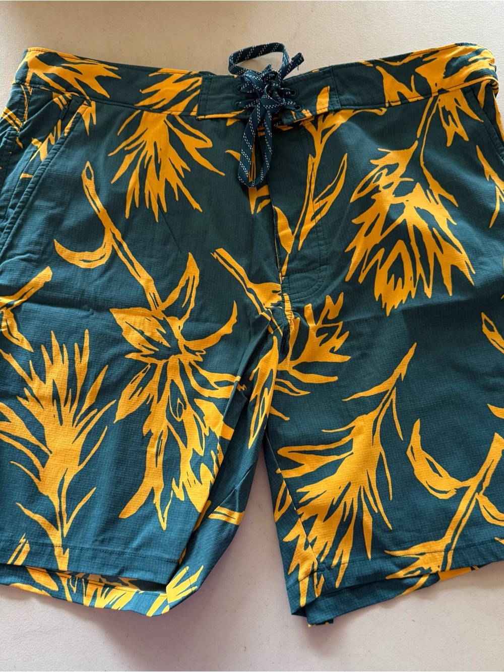 The North Face Green Swim Shorts with Yellow Floral Print